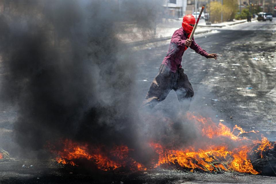 Protesters burn tires to block roads during a demonstration demanding the return of electricity in Basra, southeast of Baghdad, Iraq, Friday, July 2, 2021. A widespread power outage is hitting Iraq as temperatures reach scorching levels, affecting even affluent areas in the capital and stirring concerns of widespread unrest. (AP Photo/Nabil al-Jurani)