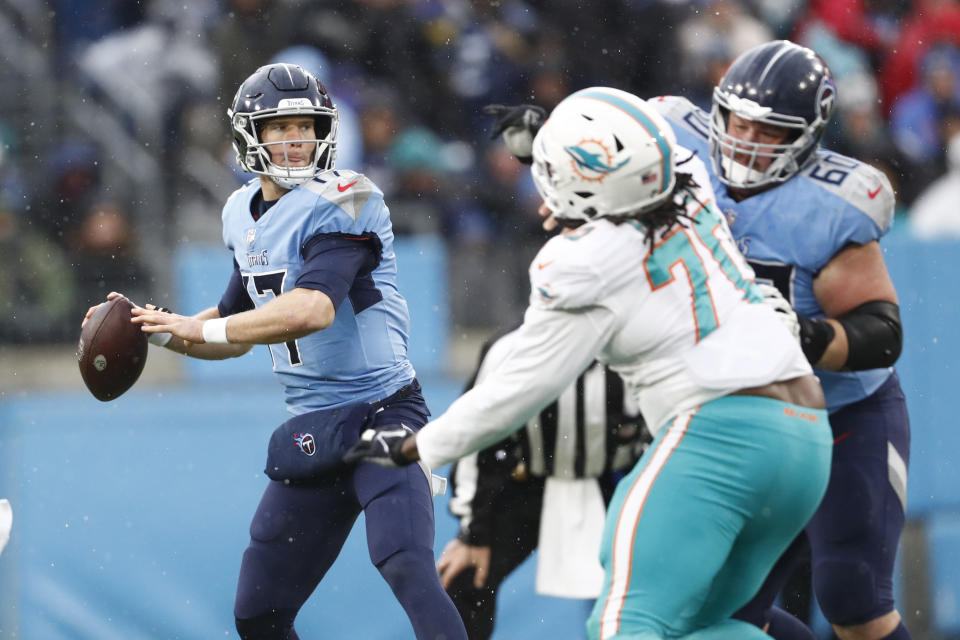 Tennessee Titans quarterback Ryan Tannehill (17) passes as he is pressured by Miami Dolphins defensive tackle Adam Butler (70) in the first half of an NFL football game Sunday, Jan. 2, 2022, in Nashville, Tenn. (AP Photo/Wade Payne)