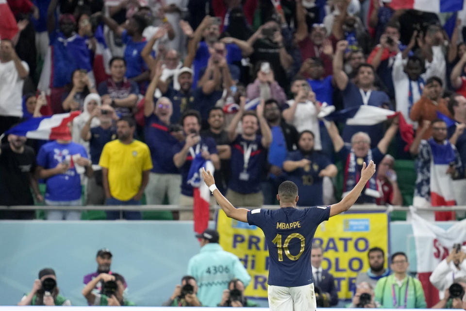 France's Kylian Mbappe celebrates after scoring his side's third goal during the World Cup round of 16 soccer match between France and Poland, at the Al Thumama Stadium in Doha, Qatar, Sunday, Dec. 4, 2022. (AP Photo/Natacha Pisarenko)