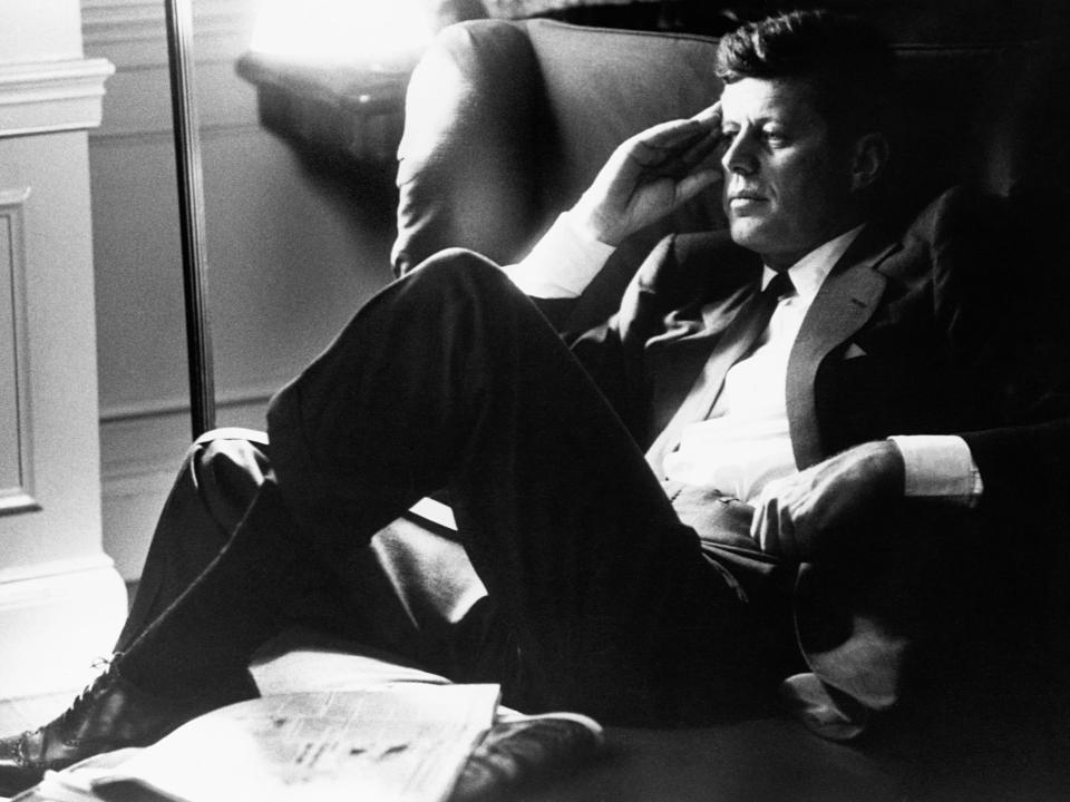 Presidential candidate John F. Kennedy relaxes in his Boston apartment.