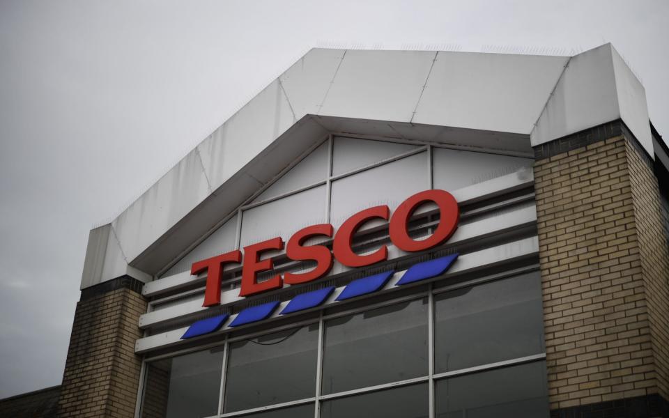 In this file photo taken on September 30, 2019 Signage is seen outside a Tesco Superstore in south London - Tolga Akmen/AFP