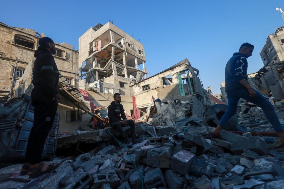 Palestinians inspect a building damaged during Israeli bombardment in Rafah in the southern Gaza Strip (AFP via Getty)