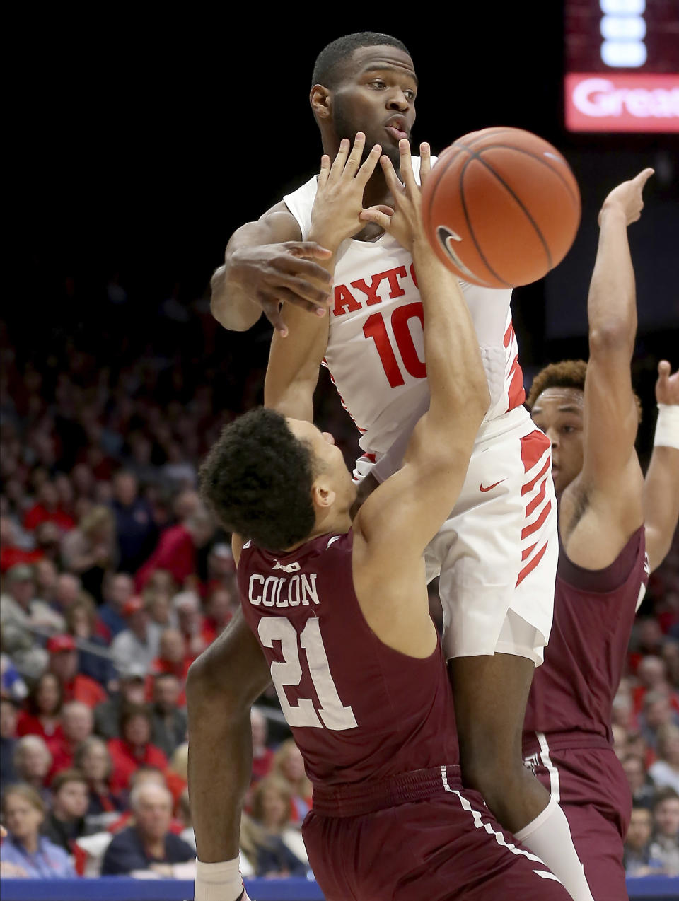 Dayton's Jalen Crutcher (10) passes the ball as he drives to the basket against Fordham's Josh Colon (21) during the first half of an NCAA college basketball game Saturday, Feb. 1, 2020, in Dayton, Ohio. (AP Photo/Tony Tribble)
