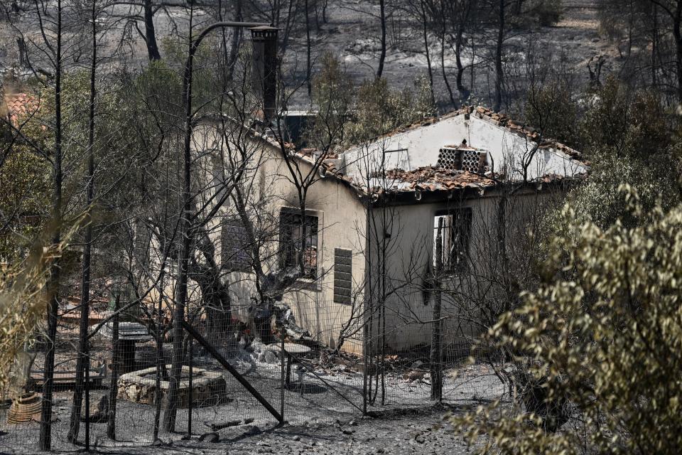 A burned-out house during a wildfire near Mandra.