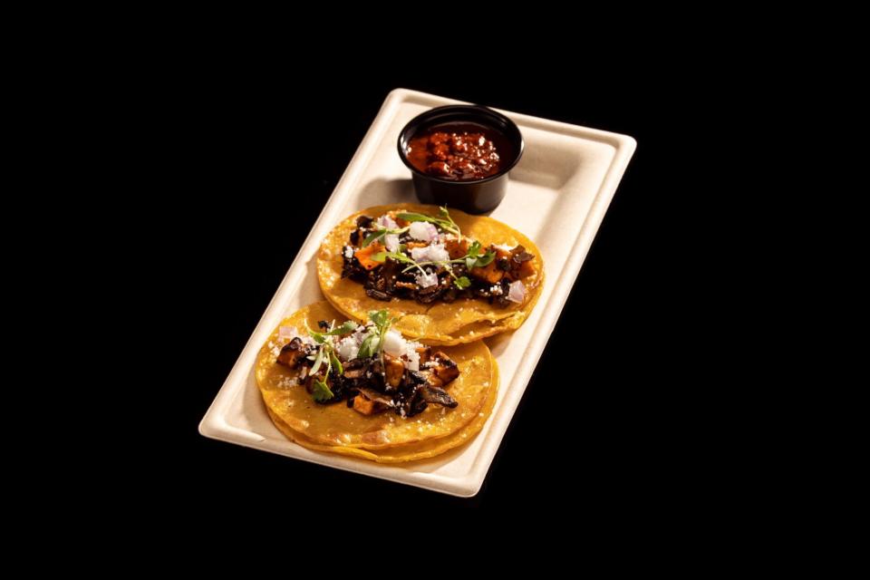 Roasted Sweet Potato & Mushroom Street Tacos (vegan and gluten-free): roasted sweet potato and mushroom tacos topped with onions, vegan crumbled cheese and cilantro; also served with birria consommé.