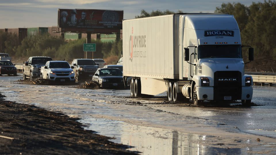 Traffic is slowed as water and mud from Tropical Storm Hilary covers part of Interstate 10, between Indio and Palm Springs, California, on Monday. - David Swanson/AFP/Getty Images