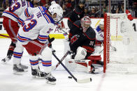 Carolina Hurricanes goaltender Frederik Andersen (31) watches the puck controlled by New York Rangers' Adam Fox (23) during the first period in Game 4 of an NHL hockey Stanley Cup second-round playoff series in Raleigh, N.C., Saturday, May 11, 2024. (AP Photo/Karl B DeBlaker)