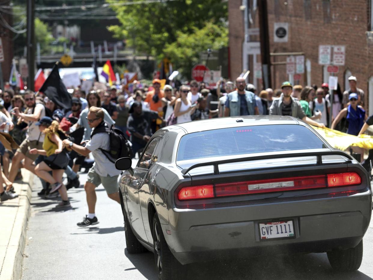 A car drives into protesters in Charlottesville, Virginia. One person was killed and more were injured: AP Photo