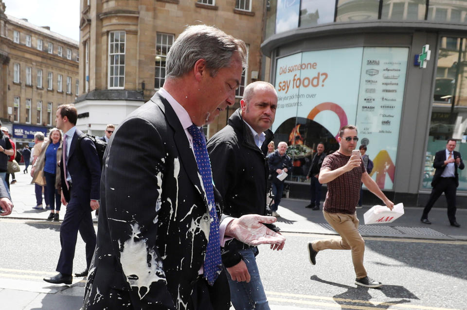 Brexit Party leader Nigel Farage gestures after being hit with a milkshake while arriving for a Brexit Party campaign event in Newcastle, Britain, May 20, 2019. REUTERS/Scott Heppell