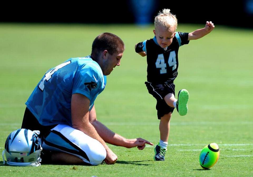 Luke Jansen, right, follows through on his kick as his father Carolina Panthers long snapper J.J. Jansen maintains his placement following practice at Wofford College on Sunday, July 31, 2016.