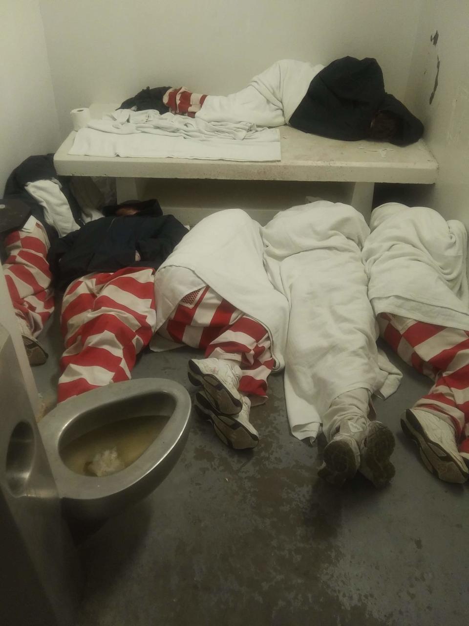 This undated photo taken by an inmate at Mississippi State Penitentiary at Parchman and provided to The Associated Press shows inmates seen lying on the floor next to a full toilet. After violence at the prison on Jan. 2, 2020, guards and state troopers marched some prisoners at Parchman into Unit 32, a cell block closed in 2011 as part of a settlement; the inmate says the unit has no running water or mattresses, and is plagued by mold and issues. (Courtesy photo via AP)