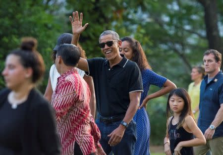 Former President Barack Obama (C) waves while walking with his daughter Malia during a visit to the 9th-century Borobudur Temple in Magelang, Central Java, Indonesia June 28, 2017. REUTERS/Pius Erlangga