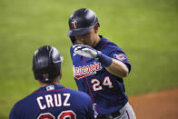 Minnesota Twins Trevor Larnach (24) celebrates with Nelson Cruz after Larnach hit a solo home run during the fifth inning of the team's baseball game against the Texas Rangers in Arlington, Texas, Friday, June 18, 2021. (AP Photo/Andy Jacobsohn)