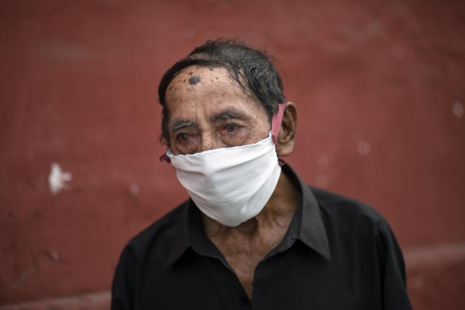 Ciro Orlando Gijon, 78, waits to apply for shelter at the Plaza de Toros de Acho bullring, in Lima, Peru, March 31, 2020. The mayor of Lima reported that the plaza will provide shelter and balanced meals for some of the city's homeless amid the new coronavirus pandemic. (AP Photo/Rodrigo Abd)