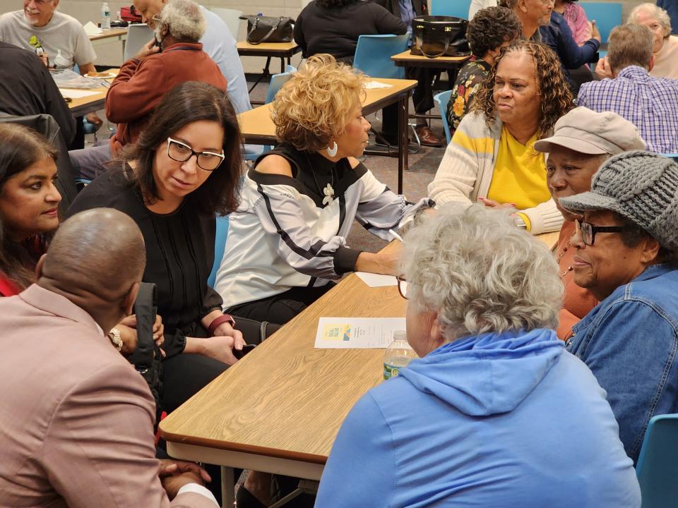 Audience members at a National Day of Racial Healing event in Cocoa on Tuesday broke into small groups to discuss their own experiences with race and brainstorm ways to overcome racial and political divisions in the community.