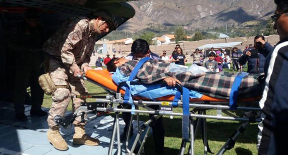 A person is transported to a helicopter after eating contaminated food at a funeral in the Peruvian Andes in Ayacucho, Peru.