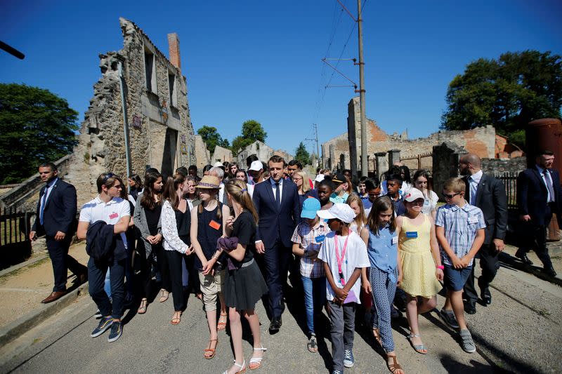 FILE PHOTO: French President Emmanuel Macron attends a visit of the ruins in the French martyr village of Oradour-sur-Glane