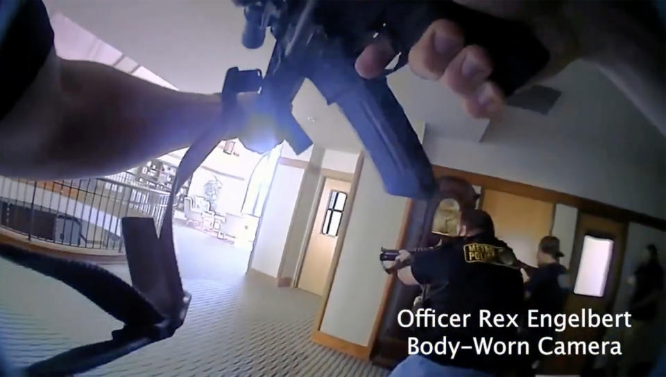 This image provided by Metropolitan Nashville Police Department shows bodycam footage of police responding to an active shooting at The Covenant School in Nashville, Tenn., on Monday, March 27, 2023. The former student who shot through the doors of the Christian elementary school and killed three children and three adults had drawn a detailed map of the school. (Metropolitan Nashville Police Department via AP)