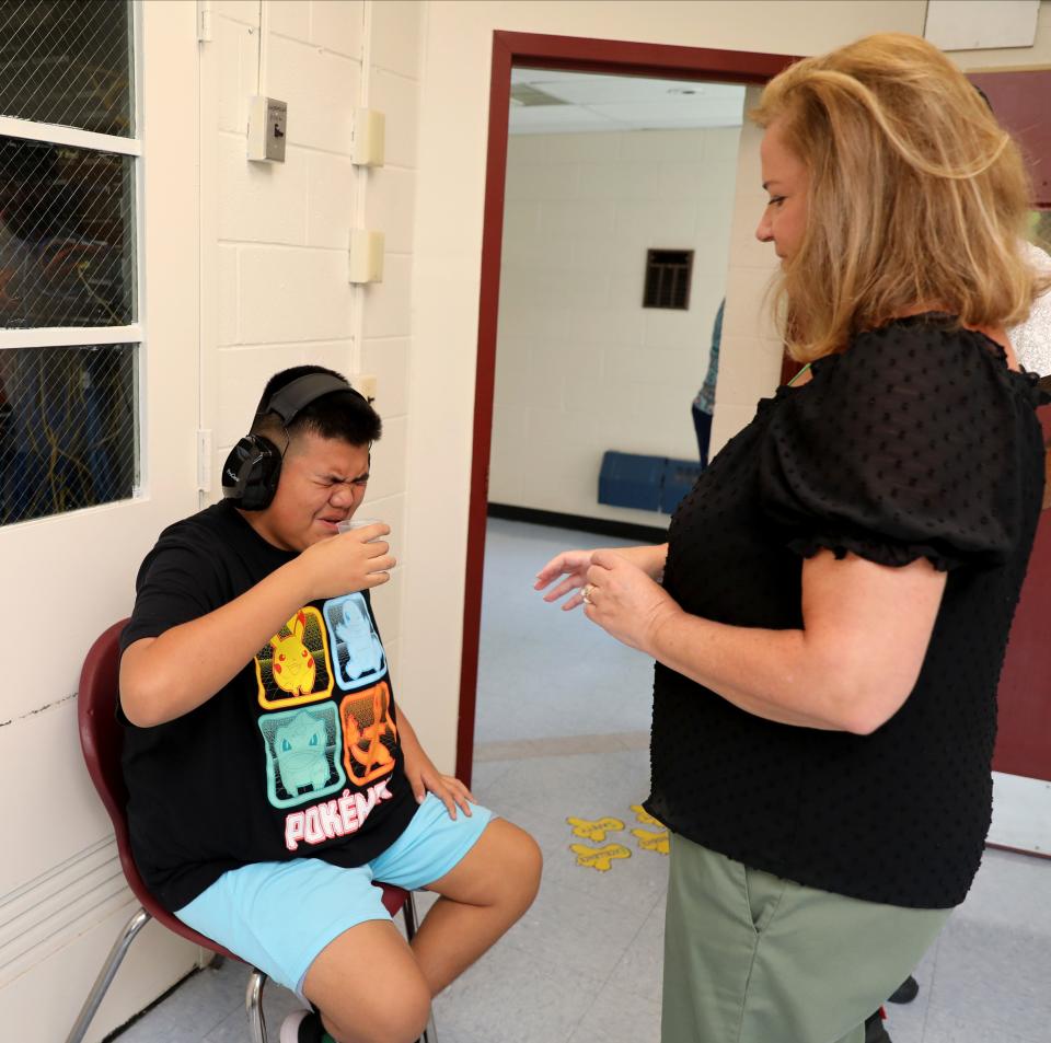 Eileen Vero, a Licensed Practical Nurse watches as student Juan Flores, 13, takes his medicine in the nurses office, at the Jesse J. Kaplan School in West Nyack, Oct. 5, 2023.