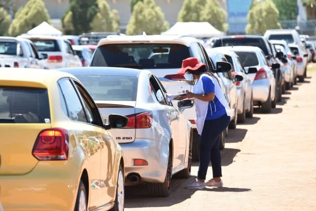 A worker helps a person register for the COVID-19 vaccine at a drive-through COVID-19 vaccination site in Gaborone, Botswana, on Oct. 12, 2021.(TSHEKISO TEBALO/XINHUA VIA GETTY IMAGES) Image courtesy of U.S. News