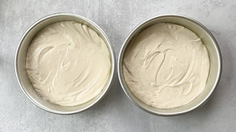 Bright and sunny lemon lavender cake batter in round cake pans