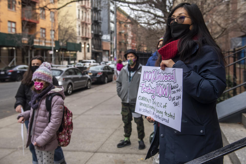 Jia Lee, right, a 4th and 5th grade teacher, leads a meeting for teachers from the Earth school to speak out on issues related to lack of COVID testing on Tuesday, Dec. 21, 2021, in New York. (AP Photo/Brittainy Newman)