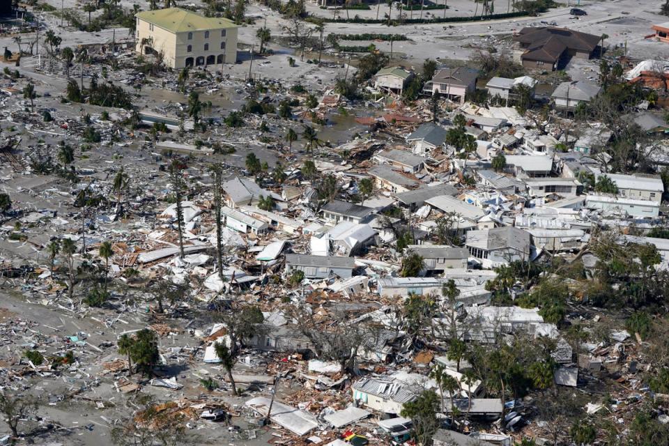 Damaged homes and debris are shown in the aftermath of the hurricane in Fort Myers (AP)