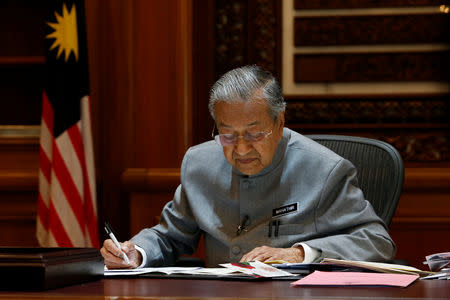 FILE PHOTO: Malaysia's Prime Minister Mahathir Mohamad works at his office in Putrajaya, Malaysia June 19, 2018. REUTERS/Lai Seng Sin/File photo