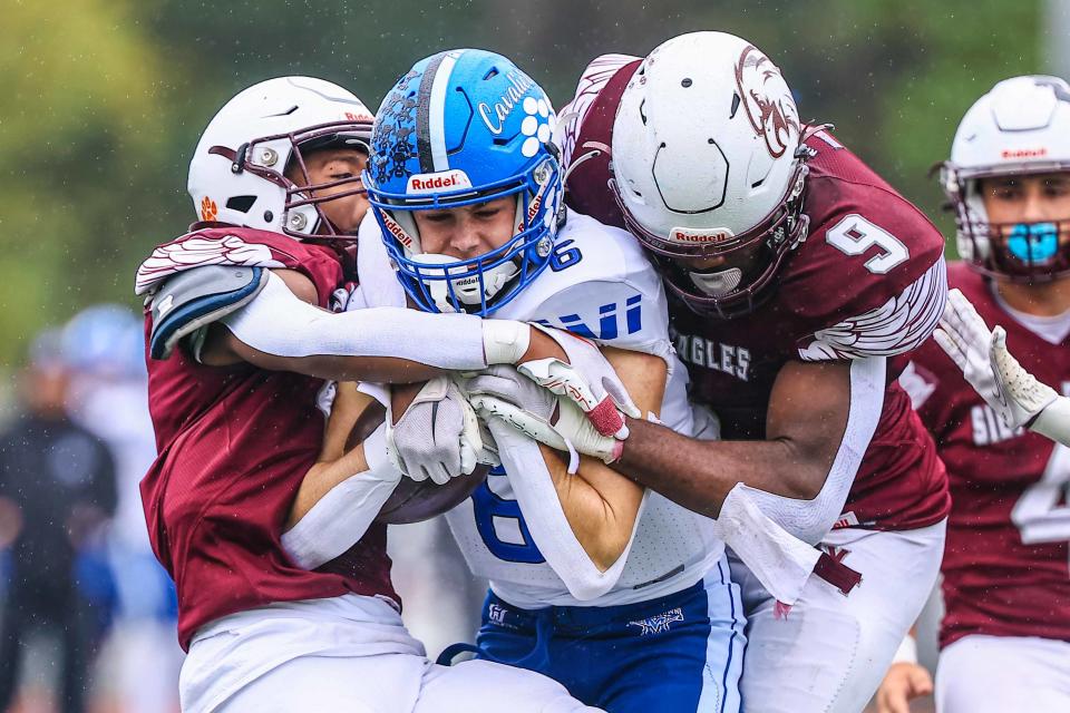 Middletown Cavaliers wide receiver Matthew Priestley (6) is tackled by defensive end Rikye Jenkins (9) during a regular season game between Hodgson and Middletown Saturday, Oct. 14, 2023, at Bob Peoples Stadium on the campus of Caravel Academy in Bear, DE.