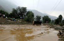 Workers clear the Central Highway after a mudslide in Huarochiri, Lima, Peru, March 23, 2017. REUTERS/Guadalupe Pardo