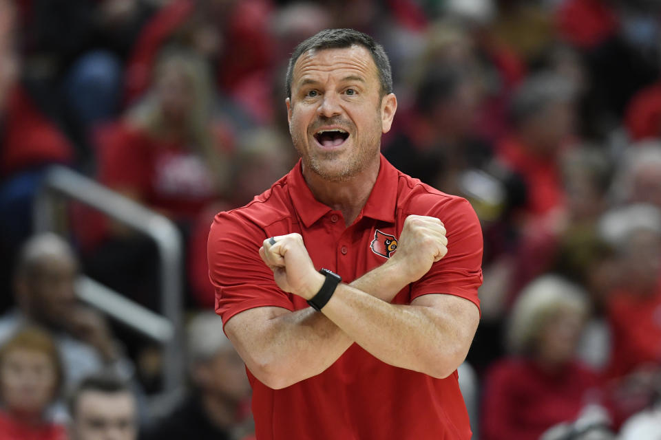 Louisville head coach Jeff Walz signals a play in to his team during the first half of their women's NCAA Tournament college basketball first round game against Albany in Louisville, Ky., Friday, March 18, 2022. (AP Photo/Timothy D. Easley)