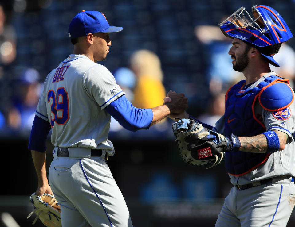 New York Mets relief pitcher Edwin Diaz (39) shakes hands with catcher Tomas Nido (3) following a baseball game against the Kansas City Royals at Kauffman Stadium in Kansas City, Mo., Sunday, Aug. 18, 2019. The Mets defeated the Royals 11-5. (AP Photo/Orlin Wagner)