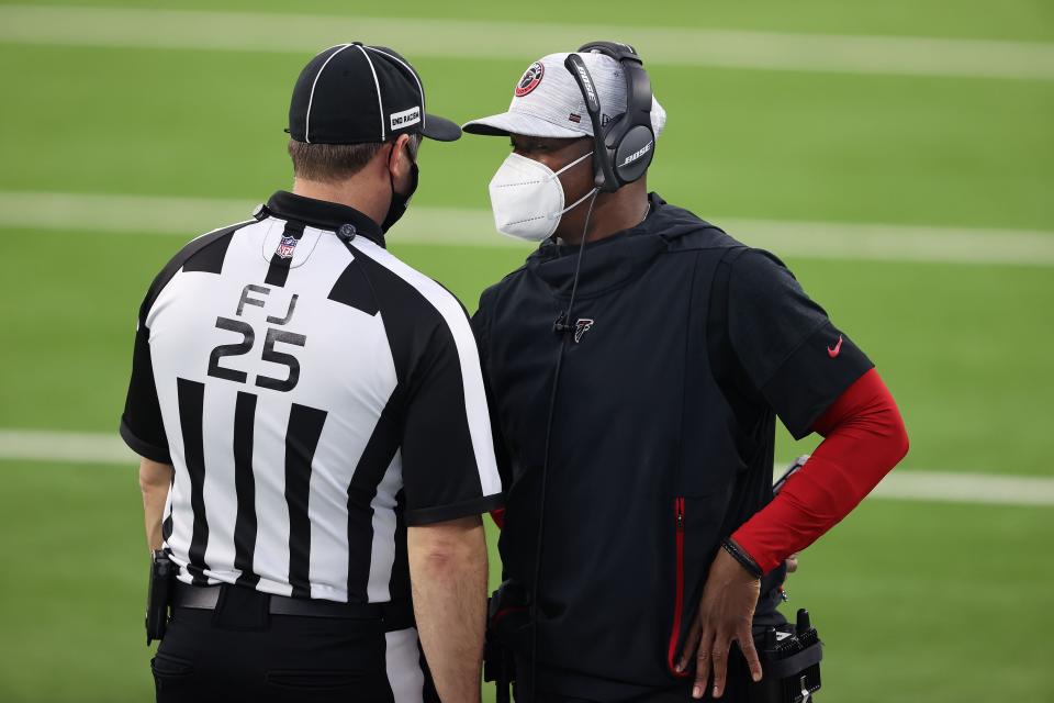 INGLEWOOD, CALIFORNIA - DECEMBER 13:  Head coach Raheem Morris of the Atlanta Falcons discuses the call with field judge Bob Waggoner #25 during the fourth quarter against the Los Angeles Chargers at SoFi Stadium on December 13, 2020 in Inglewood, California. (Photo by Sean M. Haffey/Getty Images)