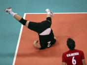 Germany's Markus Steuerwald falls during a play during their men's Group B volleyball match against the U.S. at the London 2012 Olympic Games at Earls Court July 31, 2012.