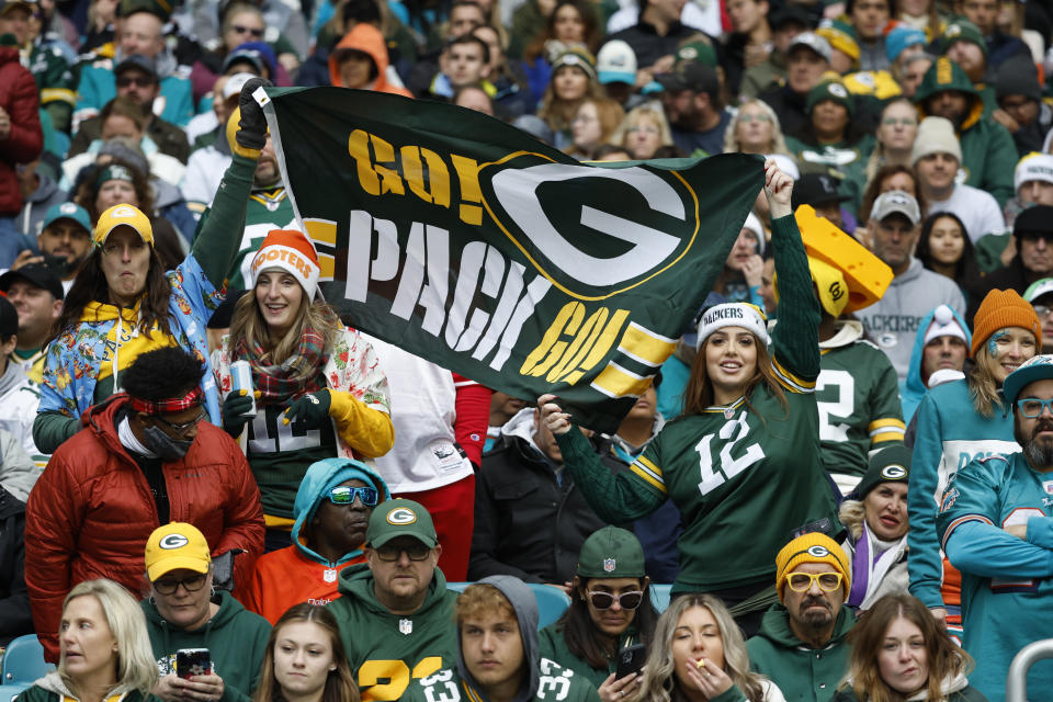 Green Bay Packers fans cheer on their team during the first half of an NFL football game against the Miami Dolphins, Sunday, Dec. 25, 2022, in Miami Gardens, Fla. (AP Photo/Rhona Wise)