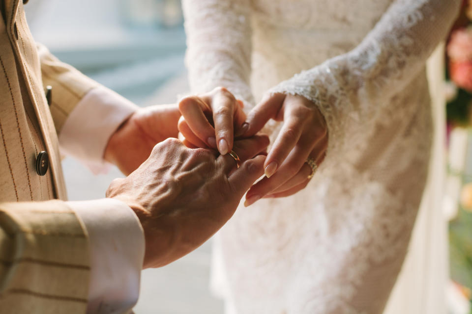 Couple exchanging rings on their wedding day