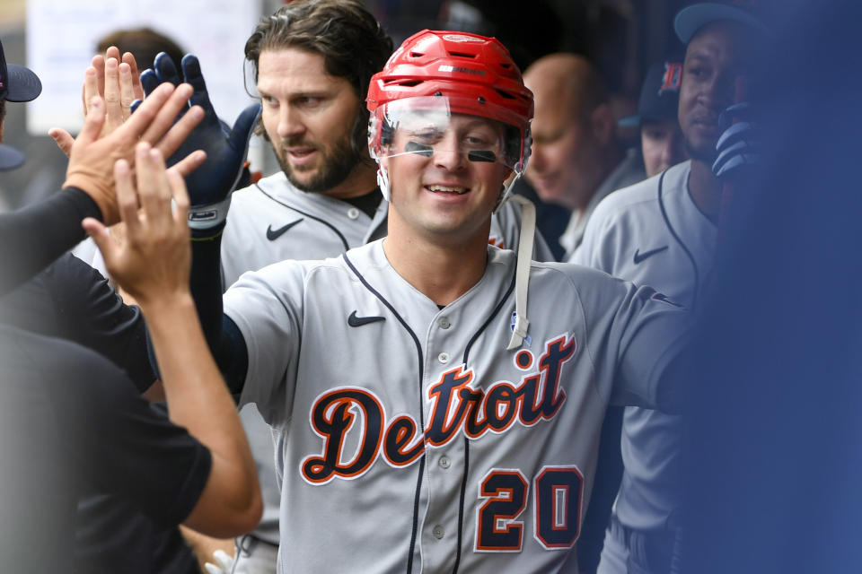 Detroit Tigers first baseman Spencer Torkelson, wearing the celebratory hockey helmet, celebrates in the dugout after hitting a two-run home run against the Minnesota Twins during the fifth inning of a baseball game, Sunday, June 18, 2023, in Minneapolis. (AP Photo/Craig Lassig)