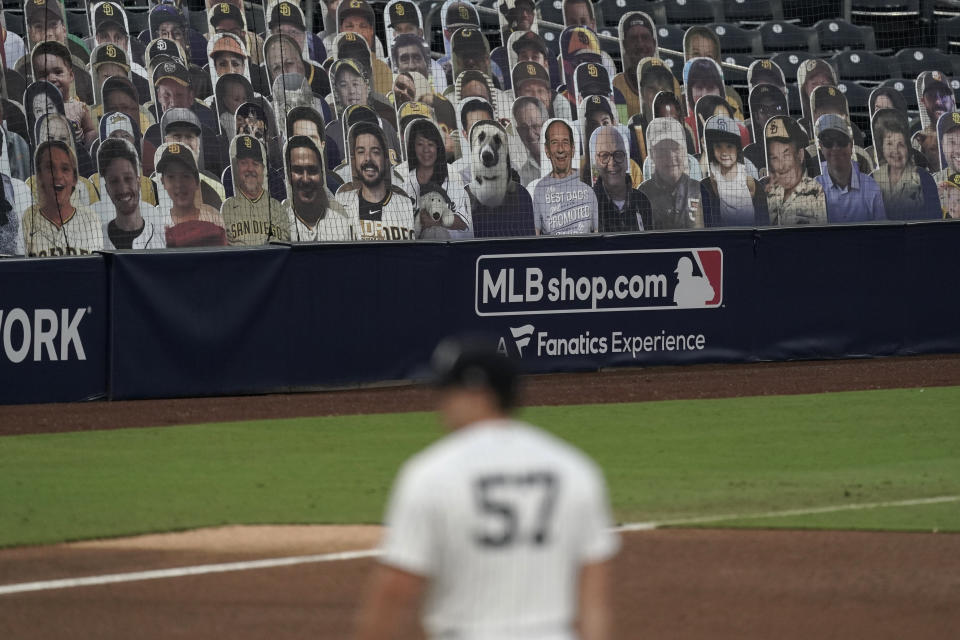 Cutouts of fans fill seats during Game 3 of a baseball American League Division Series between the Tampa Bay Rays and the New York Yankees, Wednesday, Oct. 7, 2020, in San Diego. (AP Photo/Jae C. Hong)