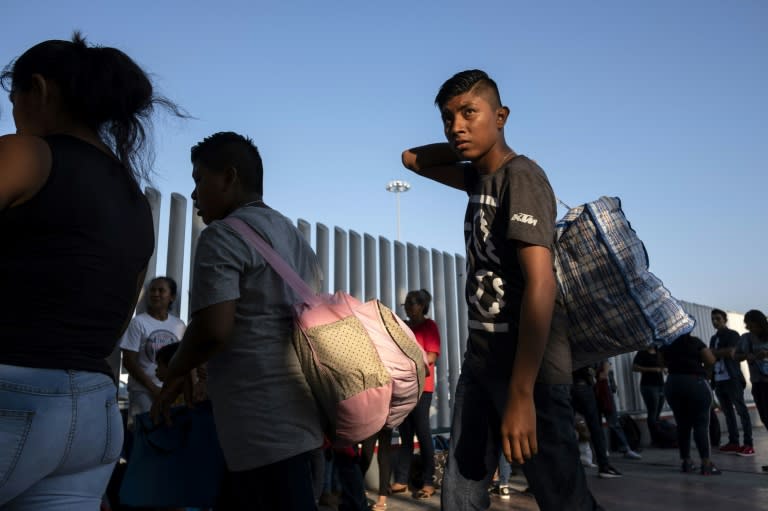 Asylum seekers gather at El Chaparral port of entry in Tijuana, Mexico as they seek an appointment to present their asylum request to US authorities