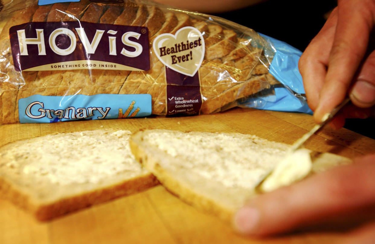 Hovis Bread being buttered; a Premier Foods brand. (Photo by: Newscast/Universal Images Group via Getty Images)
