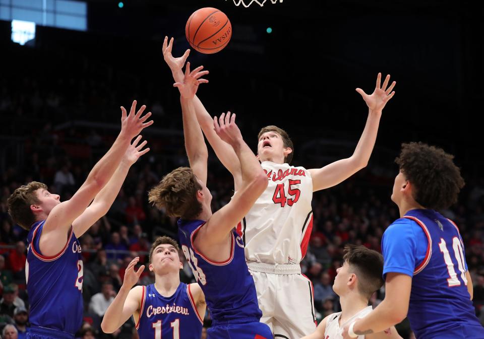 Hiland forward Alex Yoder, center, looks to bring down a rebound against a host of Crestview defenders during the first half of a Division IV state semifinal basketball game at UD Arena, Friday, March 17, 2023, in Dayton, Ohio.