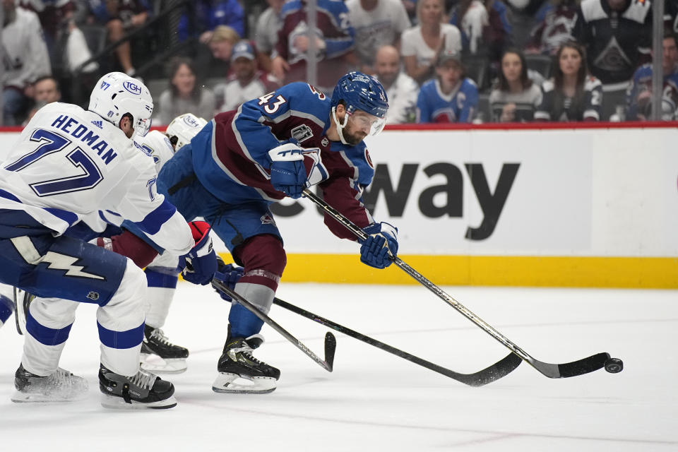 Colorado Avalanche center Darren Helm (43) shoots for a goal during the second period against the Tampa Bay Lightning in Game 2 of the NHL hockey Stanley Cup Final, Saturday, June 18, 2022, in Denver. (AP Photo/John Locher)