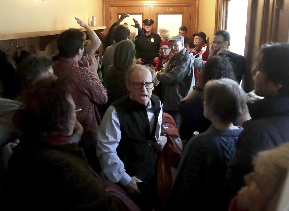 Opponents of an extraordinary session bill submitted by the state's Republicans chant outside the session at the Wisconsin State Capitol in Madison, Wis., Monday, Dec. 3, 2018. (John Hart/Wisconsin State Journal via AP)