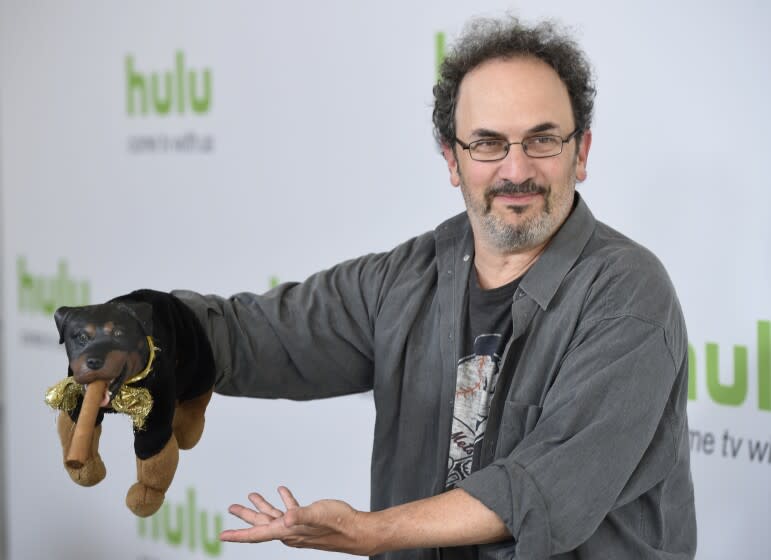 FILE - Robert Smigel, creator, executive producer and voice of "Triumph the Insult Comic Dog," poses with the puppet during the Television Critics Association 2016 Summer Press Tour at the Beverly Hilton on Aug. 5, 2016, in Beverly Hills, Calif. Federal prosecutors on Monday, July 18, 2022, declined to bring charges against Smigel and eight others associated with CBS' "Late Show with Stephen Colbert" who were arrested in a building in the U.S. Capitol complex last month. (Photo by Chris Pizzello/Invision/AP, File)