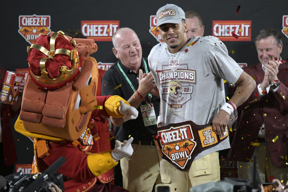 Florida State quarterback Jordan Travis is presented a belt after being named the most valuable player in the team's win in the Cheez-It Bowl NCAA college football game against Oklahoma, Thursday, Dec. 29, 2022, in Orlando, Fla. (AP Photo/Phelan M. Ebenhack)