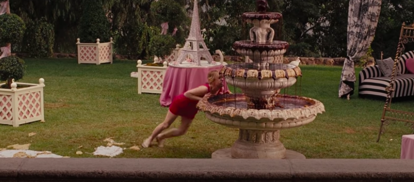 A woman tries to push over a chocolate fountain