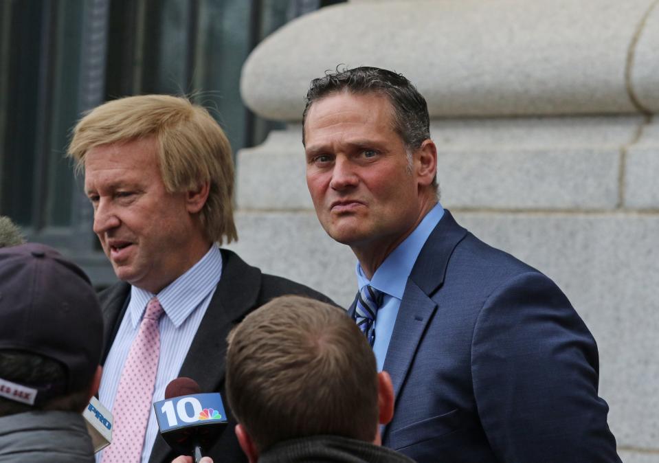 James E. Doyle II, right, former state senator from Pawtucket, with attorney Jeffrey Pine, leaves federal court after his sentencing.