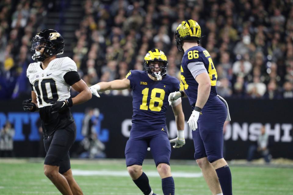 Michigan Wolverines tight ends Colston Loveland (18) celebrates with Luke Schoonmaker (86) after a catch against the Purdue Boilermakers during the second half of the Big Ten championship game at Lucas Oil Stadium in Indianapolis, Saturday, Dec. 3, 2022.