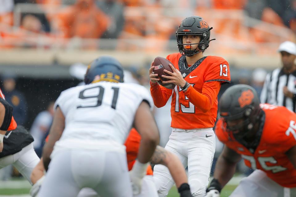 Oklahoma State Cowboys quarterback Garret Rangel (13) drops back to pass during a college football game between Oklahoma State and West Virginia at Boone Pickens Stadium in Stillwater, Okla., Saturday, Nov. 26, 2022. West Virginia won 24-19. 