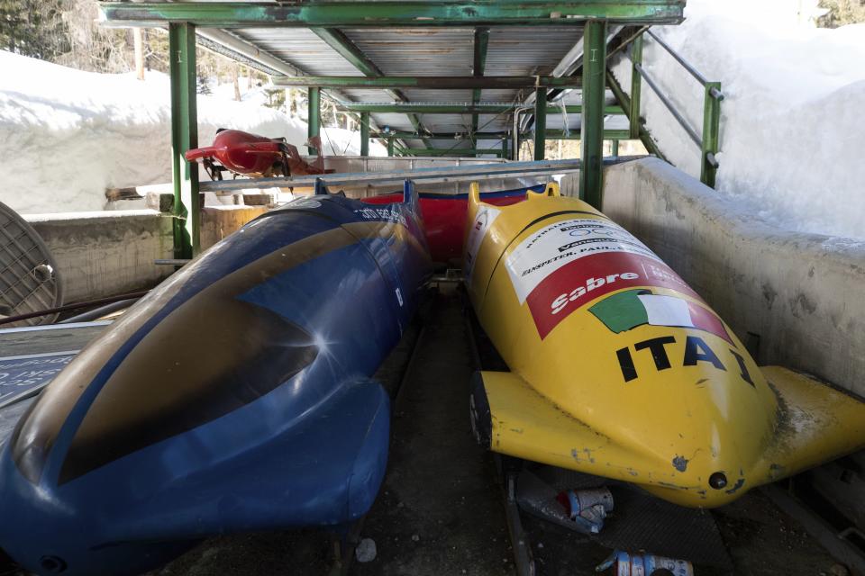Bobsleds are parked next to the track in Cortina d’Ampezzo, Italy, Wednesday, Feb. 17, 2021. A big-ticket project for the 2026 Milan-Cortina Olympics has been dropped because the Italian government no longer wants to help fund it, organizing committee officials said Monday, Oct. 16, 2023. | Gabriele Facciotti, Associated Press